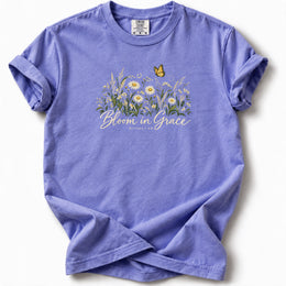 Bloom in Grace Premium T-Shirt in Flo Blue, front view with wildflowers and butterfly artwork