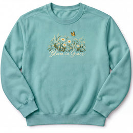 Bloom in Grace Premium Sweatshirt in Seafoam, front view with wildflowers and butterfly artwork