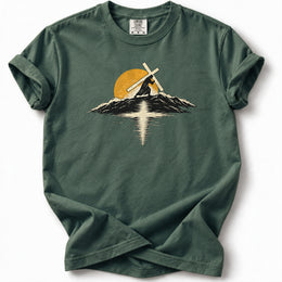 Carry the Light Premium T-Shirt in Blue Spruce, front view with cross-bearing silhouette, mountains and sun