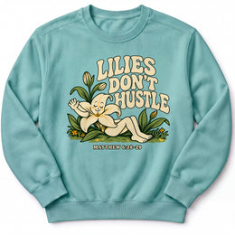 Lilies Don’t Hustle Premium Sweatshirt in Seafoam, front view with botanical character inspired by Matthew 6:28–29