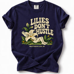 Lilies Don’t Hustle Premium T-Shirt in True Navy, front view with botanical character inspired by Matthew 6:28–29